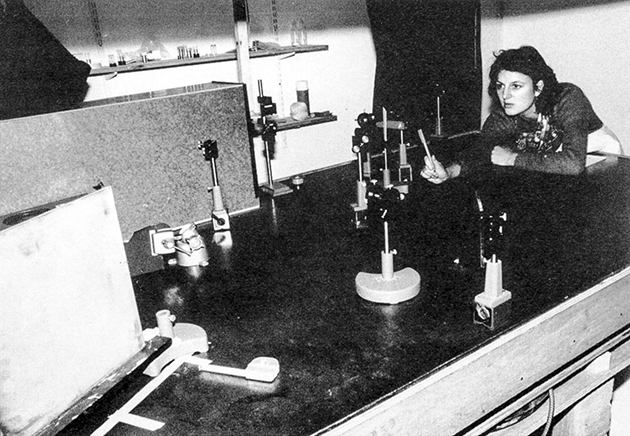Susan Gamble aligns optical components for The Body in Question series of holograms in 1982. The laser is housed in the box in the top left and the white screen in the bottom left is a diffuser.